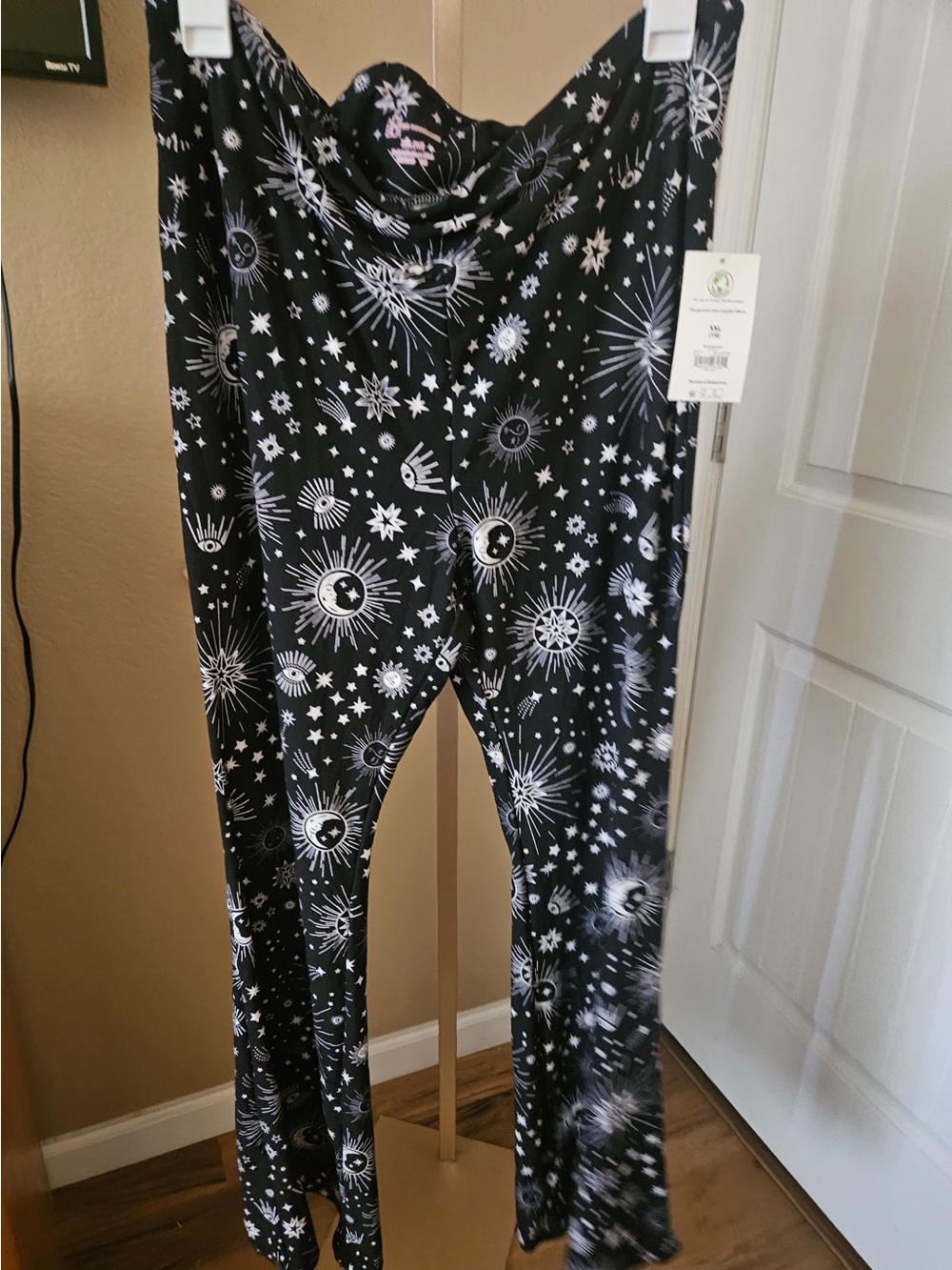 No Boundaries Juniors Flare Pants, with a celestial moon and stars pattern.